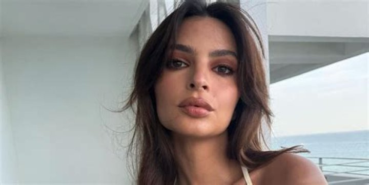 Emily Ratajkowski Shares Swimsuit Photos Reading "Working Girl"