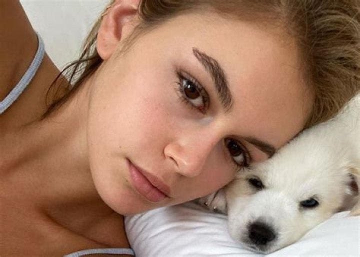Kaia Gerber Wears A Two-Piece Bathing Suit And Snuggles Two Cuddly Puppies As She’s Photographed Without Her Cast